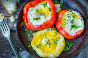 Delicious dish with fried eggs in yellow and red bell pepper