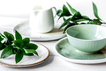 ceramic tableware with flowers on white background