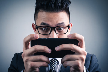 The abstract image of the  gamer playing video game by the smartphone. the concept of activities, gaming, technology, lifestyle, education, e-sport and internet of things.