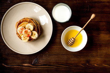 cooked pancake on plate top view at wooden background