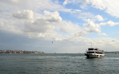 View to Istanbul and passenger ferry. Seagulls flying in the sky. River of the Bosphorus. Turkey