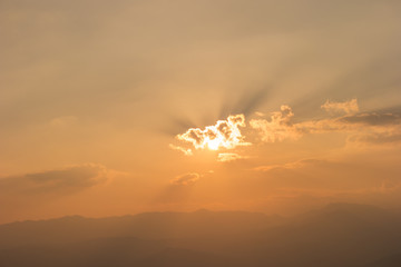 Beautiful sunset over the mountain with cloud in Thailand.