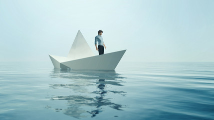 Young man navigate on paper boat