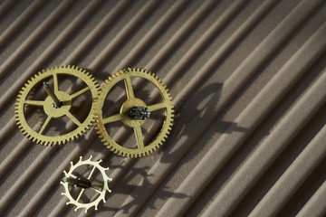 Three different toothed brass metal cog wheels