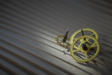Three different toothed brass metal cog wheels