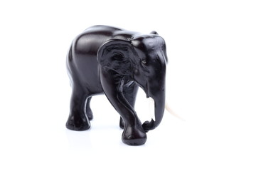 Black elephant like wooden carved with white ivory. Stand on white background, Isolated, Art Model Thai Crafts, For decoration Like in the spa.