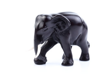 Naklejka na ściany i meble Black elephant like wooden carved with white ivory. Stand on white background, Isolated, Art Model Thai Crafts, For decoration Like in the spa.