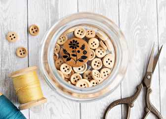 Wooden buttons in jar, vintage thread and scissors