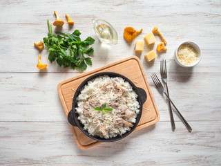 Risotto with mushrooms chanterelles on a cast iron pan.
