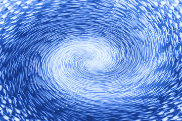 Blue wormhole in form of spiral absorbs space. Fantastic background image of asymmetric vortex...