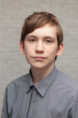 Portrait of the young Russian man at a brick wall