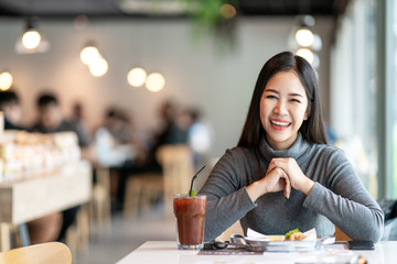 Portrait of young attractive asian woman looking at camera smiling with positive urban lifestyle...