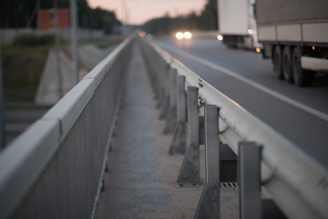 Anodized safety steel barrier on freeway bridge, close up