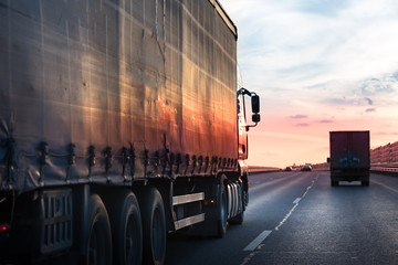 Fototapeta na wymiar Truck transportation on the road at sunset
