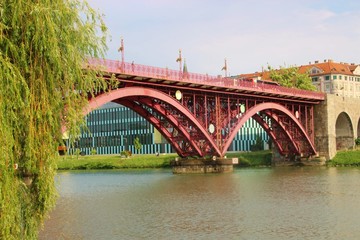 Maribor, Slovenia - July 6, 2018: The Old Bridge, or State Bridge, across the Drava river, in Maribor, Slovenia. 270 meters long, opened in 1913, with three steel arches. South-east Europe.