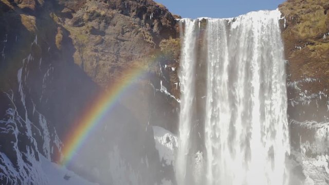 Close up view video of the beautiful Sk&oacute;gafoss Waterfall, South Iceland. Due to the amount of spray the waterfall consistently produces, a single or double rainbow is visible on sunny days.