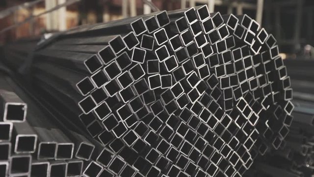 Square profile pipe, metal warehouse. Clean, metal warehouse, metal profile stacked in rows