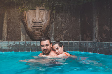 Obraz na płótnie Canvas man and woman in a pool embraced