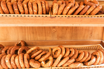 Turkish bagels lie on the shelves on a wooden background