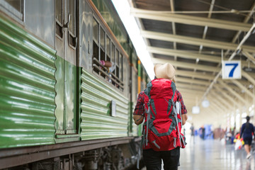backpacker lady taking map to travel in holiday by ancient train in bangkok