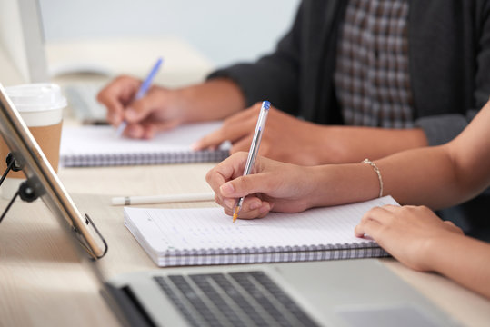 Cropped Image Of Students Writing Essay Or Assignment