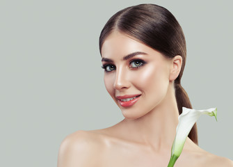 Young Woman with Makeup and Flower. Perfect Female Face