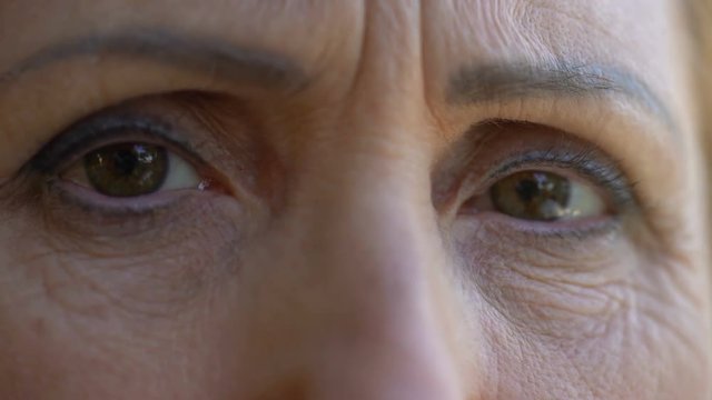 Hopeless senior woman looking into camera, worrying about future, close-up