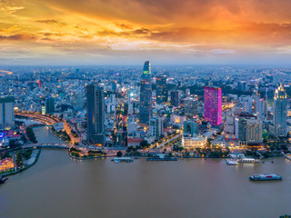 Aerial view of Ho Chi Minh City skyline and skyscrapers in center of heart business at Ho Chi Minh City downtown. Panorama of cityscape on Saigon river in Ho Chi Minh City at Vietnam at sunset scene