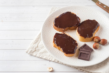 Sandwiches with chocolate hazelnut spread on the plate. Copy space