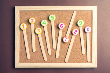 arithmetic toy Numbers 1-10 on cork board.