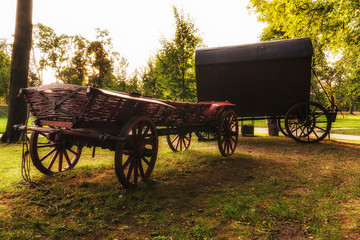 Fototapeta na wymiar Two Chuck Wagons in the Garden of Wilanow Park