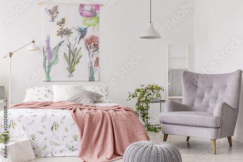 A Sunny Bedroom Interior With A Bed Dressed In Green Pattern