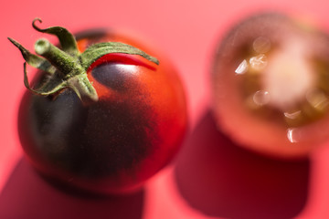 Red tomatoes on a red background. Macro.
