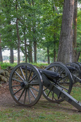 A battery of cannons behind a stone wall