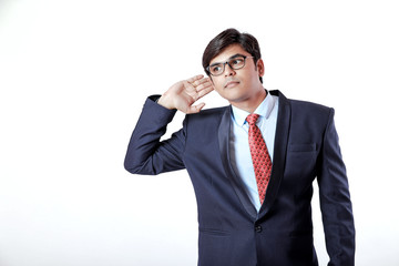 Young business man hearing something over white background