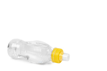 Transparent water bottle with yellow cap isolated on white background, copy space template