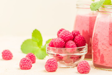 Raspberry smoothie close up photography with fresh summer blended cocktail and ripe berries.