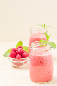Raspberry smoothie close up photography with fresh summer blended cocktail and ripe berries.