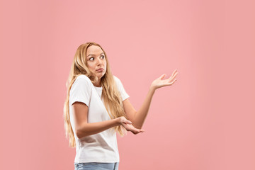 Why is that. Beautiful female half-length portrait isolated on trendy pink studio backgroud. Young emotional surprised, frustrated and bewildered woman. Human emotions, facial expression concept. - obrazy, fototapety, plakaty