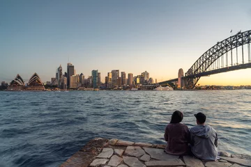 Wall murals Sydney Romantic couple looks at Sydney skyline at dusk in Sydney New South Wales, Australia.