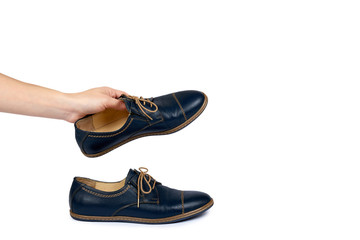 Female classic leather formal shoes with hand isolated on white background, copy space template