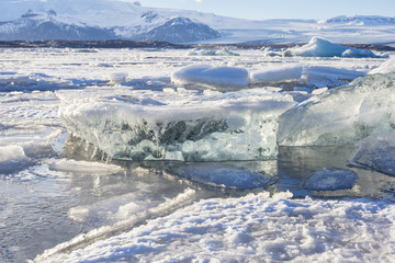 Fototapeta na wymiar Beautiful cold winter landscape with icebergs in Jökulsárlón glacial lagoon, Vatnajökull National Park, southeast of Iceland, Europe.