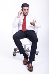 Businessman sitting on white chair isolated.