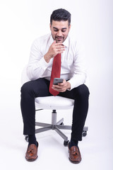 Businessman sitting on white chair isolated.