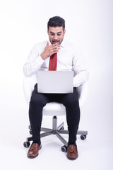 Businessman sitting on white chair isolated.