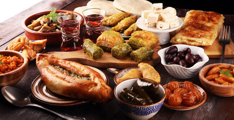 Middle eastern or arabic dishes and assorted meze, concrete rustic background. sambusak. Turkish Dessert Baklava with pistachio. Sarma. Halal food. Lebanese