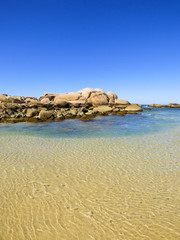Rocky shore and transparent waters at Praia da Galheta (Galheta beach) in Florianopolis, Brazil