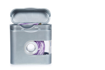 Dental floss in grey container isolated on white background, copy space template