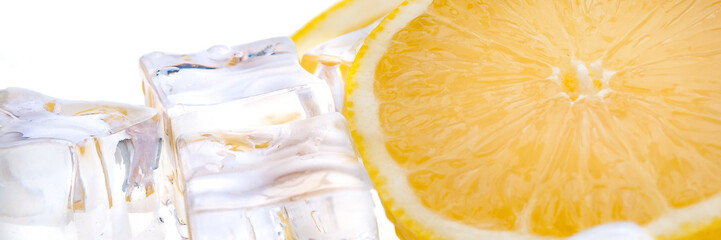 Half of juicy bright lemon and cubes of refreshing ice on white background