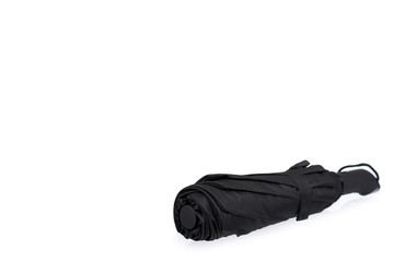 Single closed black umbrella isolated on a white background, copy space template.
